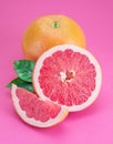 Grapefruits and grapefruit slices isolated on pink background Royalty Free Stock Photo