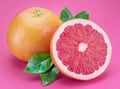 Grapefruits and grapefruit slices isolated on pink background Royalty Free Stock Photo