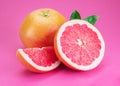 Grapefruits and grapefruit slices isolated on pink background Royalty Free Stock Photo