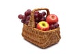 Grapes and apples in a basket on a white background Royalty Free Stock Photo