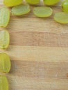 Grapes border on wooden background Royalty Free Stock Photo