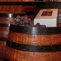 Grapes and Bottle Box on Fine Big Wine Wooden Barrel Royalty Free Stock Photo