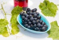 Grapes in a bowl with grape leaves Royalty Free Stock Photo