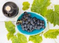 Grapes in a bowl with grape leaves Royalty Free Stock Photo