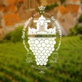 Grapes bunch with leaf and vintage press up. Wine label on vineyard and town blurred background