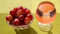 Grapes in a crystal vase with grape juice with ice on a bright green background Royalty Free Stock Photo