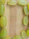 Grapes frame on wooden background Royalty Free Stock Photo