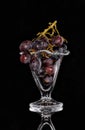Grapes in a glass ice coupe on a black background