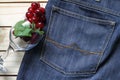 Grapes on a jeans and glass . wood background .