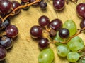 Grapes kishmish on a wooden background. The grapes are overripe. Harvest in the village