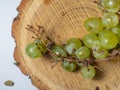 Grapes kishmish on a wooden background. The grapes are overripe. Harvest in the village