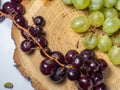 Grapes kishmish on a wooden background. The grapes are overripe. Harvest in the village