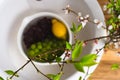 Grapes and lemon in the white sink. Kitchen top view. Fruit washing, disinfection