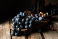 Grapes on a old wooden table. Blue grape. Black grape. Vine grape. Still life of food. Royalty Free Stock Photo