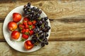Grapes and peaches and strawberries on a wooden table. Copy space. Royalty Free Stock Photo