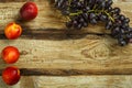 Grapes and peaches on a wooden table. Copy space. Royalty Free Stock Photo