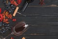 Grapes, red wine in a bottle and autumn leaves on the black wooden table Royalty Free Stock Photo