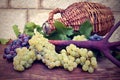 Grapes and vintage wicker bottle on the wooden table Royalty Free Stock Photo