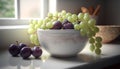 Grapes in a white bowl on the kitchen table with a window in the background Royalty Free Stock Photo