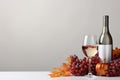 grapes wine bottle and wine glass on white table with copy space Royalty Free Stock Photo