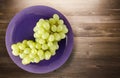 Grapes on a wooden background. grapes on a plate Royalty Free Stock Photo
