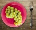 Grapes on a wooden background. grapes on a plate Royalty Free Stock Photo