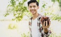 Grapes in young Asia man farmer hand holding after harvest form vineyard, healthy fruit concept Royalty Free Stock Photo