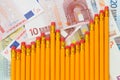 Graph of pencils against background of euro banknotes Royalty Free Stock Photo