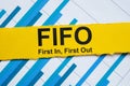 Graph and yellow stripe with inscription FIFO first in, first out. Royalty Free Stock Photo