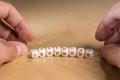 Graphene word in wooden letters and mans`s hands with a transparent and flexible foil