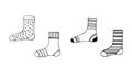 A set of socks, hand-drawn in doodle style, vector. Black and white illustration of winter, warm socks. Royalty Free Stock Photo