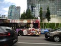 Graphic art on public bus in traffic in Singapore