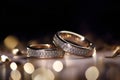 Beautiful wedding rings on a dark gold background, which are a symbol of love and commitment. Royalty Free Stock Photo