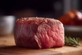 Raw, lean beef steak on a dark background. The meat is perfectly sliced and ready for cooking on a grill.