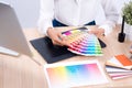 Graphic designer holding on colour chart at workplace Royalty Free Stock Photo