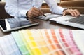 Graphic designer job with color charts at a modern office