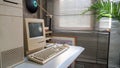 Graphic designer\'s desk in modern design studio, interior view. the first old computer. Retro device. Old original Apple Mac Royalty Free Stock Photo