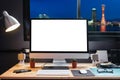 Workspace equipped with a pen tablet, a computer and white screen for text with beautiful Kobe skyline at nigh Royalty Free Stock Photo