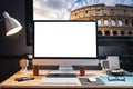Graphic designer`s workspace with a pen tablet, a computer and white backgroud for text with view of colosseum from the window Royalty Free Stock Photo