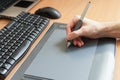 Graphic designer using digital tablet and computer in the office.