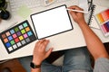 Graphic designer workspace, Male graphic designer or photo editor using digital tablet at his desk Royalty Free Stock Photo