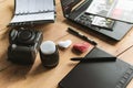 Graphic designer workstation with dslr, lens, laptop, agenda, stylus and 3d objects
