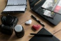 Graphic designer workstation with dslr, lens, laptop, agenda, stylus and 3d objects