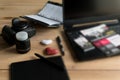 Graphic designer workstation with dslr, lens, laptop, agenda, stylus and 3d objects