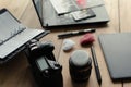 Graphic designer workstation with dslr, lens, laptop, agenda, stylus and 3d objects