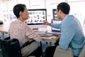 Graphic designers discussing over computer at desk in a modern office Royalty Free Stock Photo