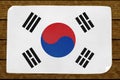 Illustration of a South KoreasÃÂ´s flag painted on the papier pasted on the woody wall Royalty Free Stock Photo