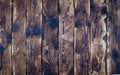 Graphic resources: Background from dark burnt boards with traces and dents from nails and an ax.