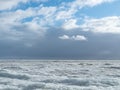 Scenery of a beautiful cloudy sky over an ice-covered pond Royalty Free Stock Photo