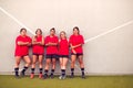 Graphic Shot Of Womens Football Team Leaning Against Wall Whilst Training For Soccer Match
